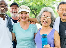 Diverse group of older adults outside exercising