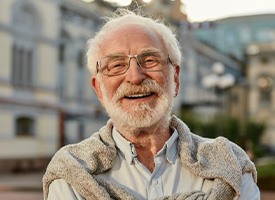 Man smiling with a beautiful building in background