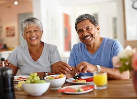 Couple in t-shirts having a healthy breakfast at a wooden table