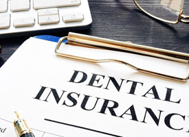 dental insurance form next to a keyboard
