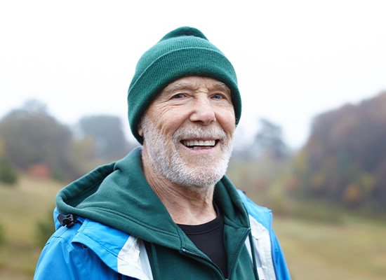 Senior man standing outside in a beanie