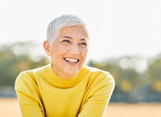 Woman with seamless smile grinning outdoors