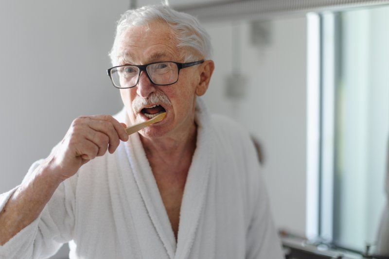 Patient about to brush their dentures